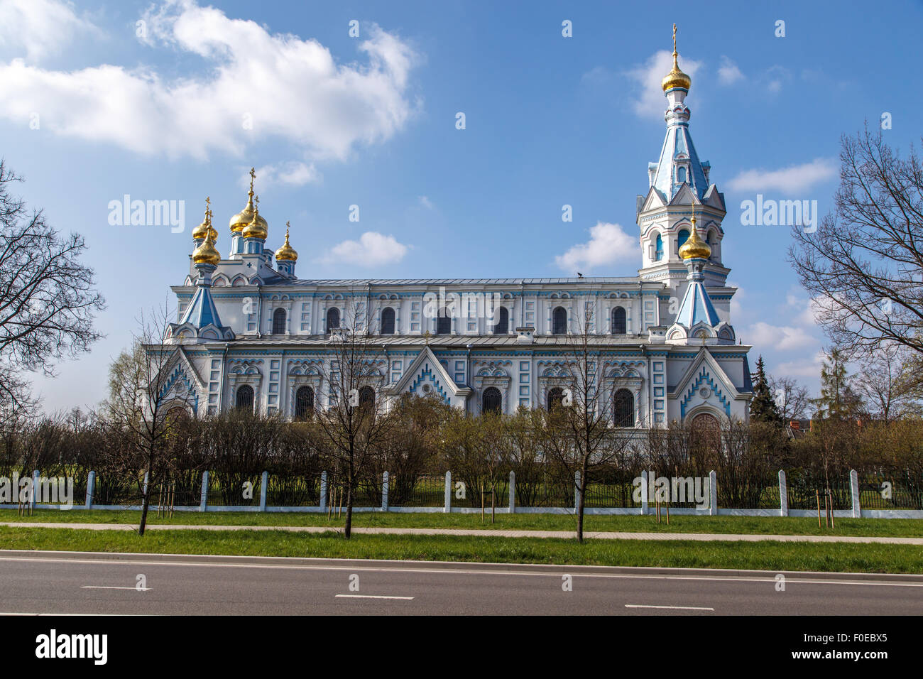 Front view of Orthodox Ss Boris and Gleb Cathedral in Dougavpils, Latvia, on blue cloudy sky background. Stock Photo