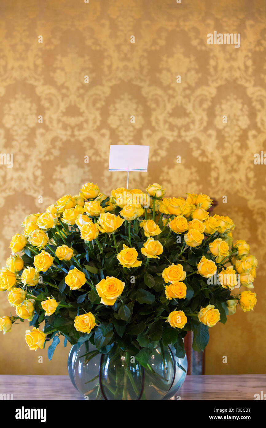 Huge bunch of yellow roses in stone vase in Quito. Ecuador. Stock Photo