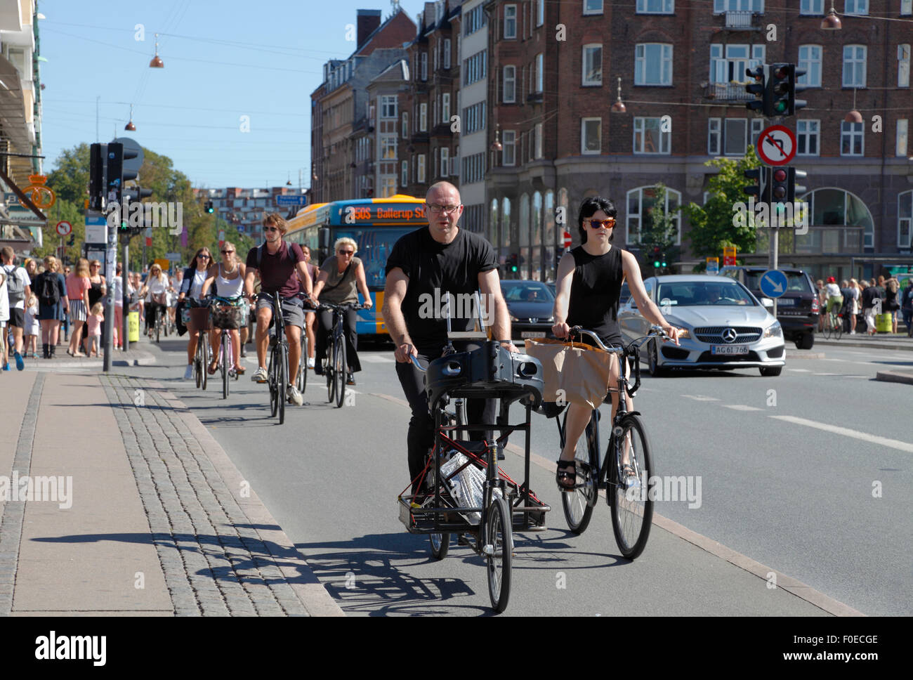 Cyclists towards the centre of Copenhagen on Torvegade at Christianshavn's Torv, Christianshavn Square, and further on bridge to central Copenhagen. Stock Photo