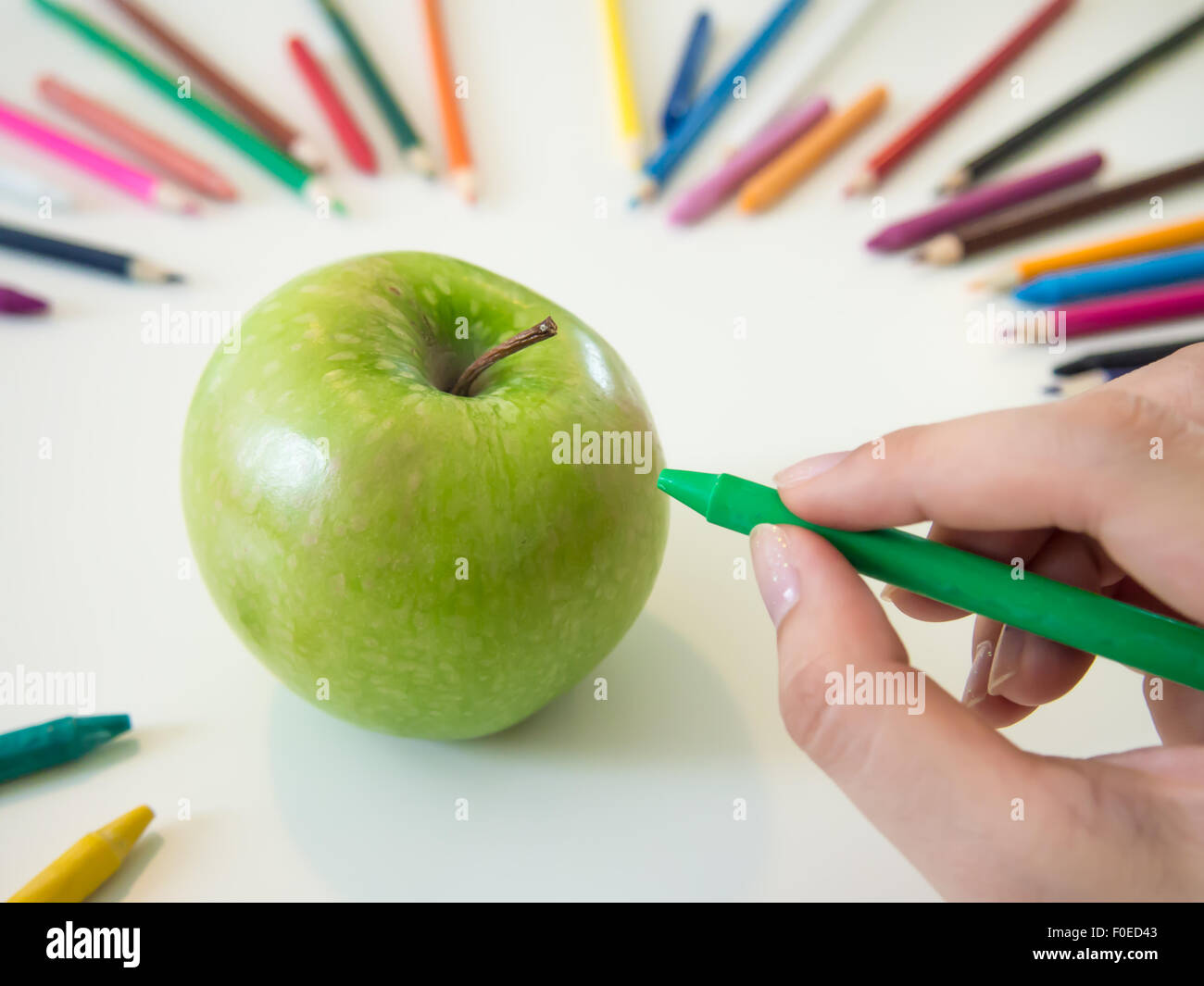 looks like drawing an apple with the colorful crayon Stock Photo
