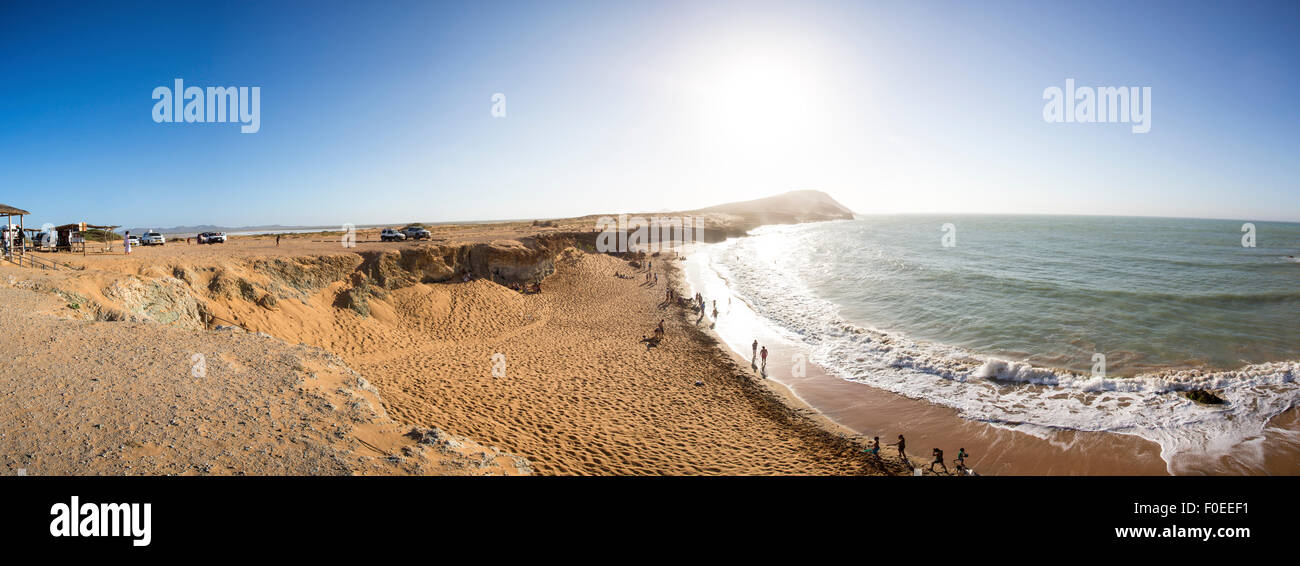 Panorama of Unidentified people having fun at a wild coastal beach of Penisula la Guajira near the Cabo de la Vela Stock Photo