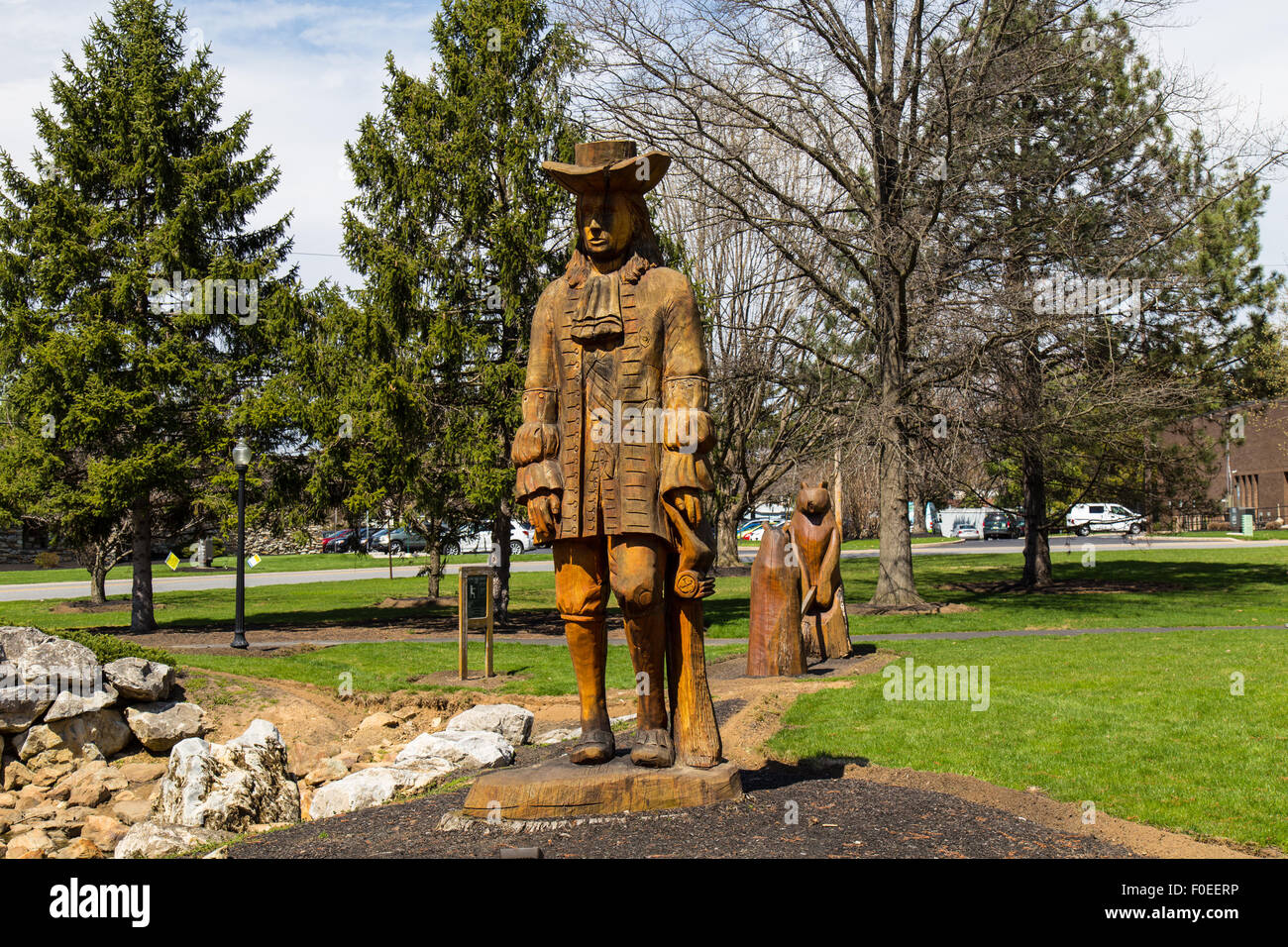 A wooden carved sculpture of Quaker William Penn in a suburban park known as Greenfield near Lancaster, PA. Stock Photo