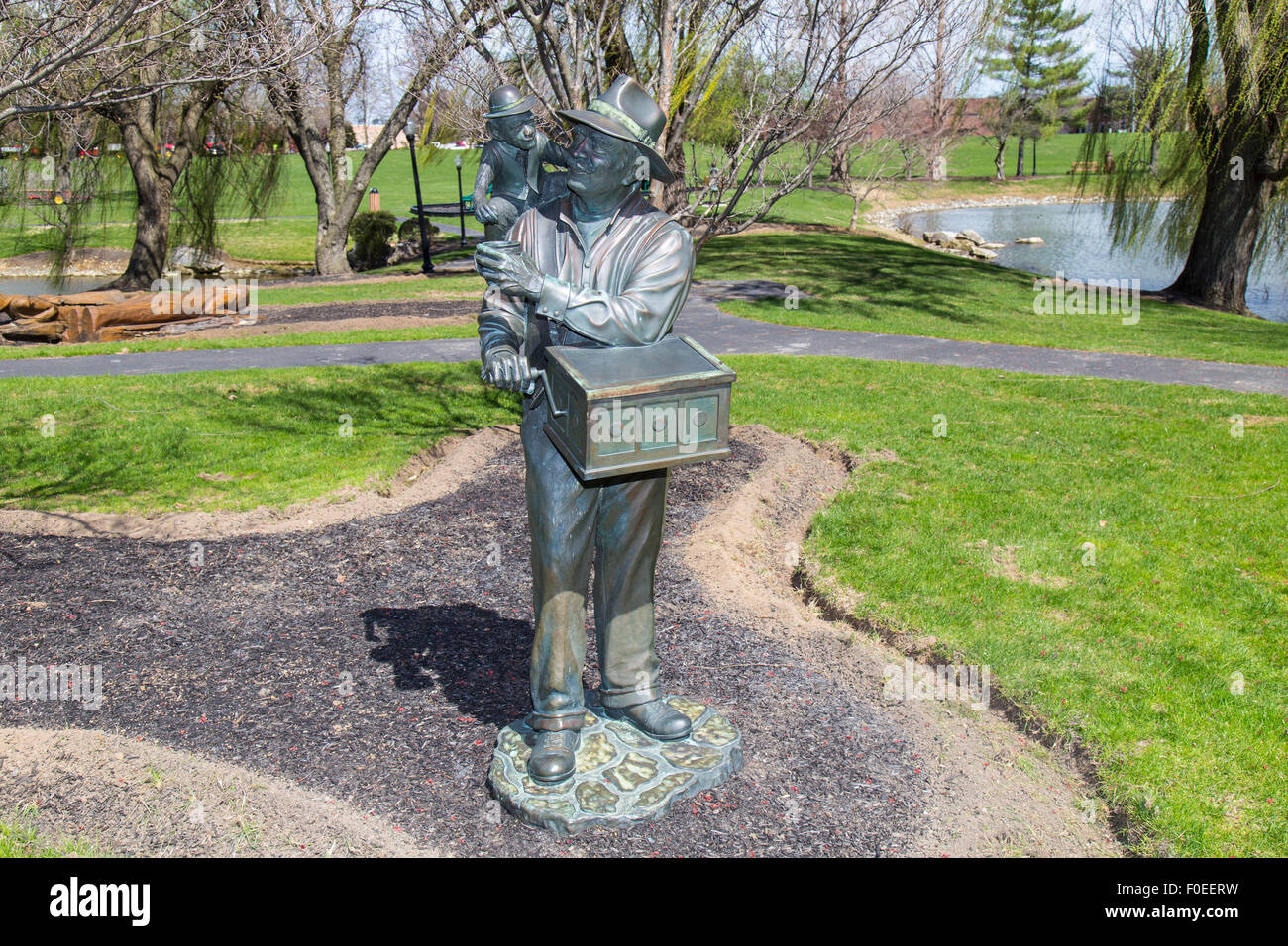 Monkey grinder sculpture at a suburban park known as Greenfield near Lancaster, PA. Stock Photo