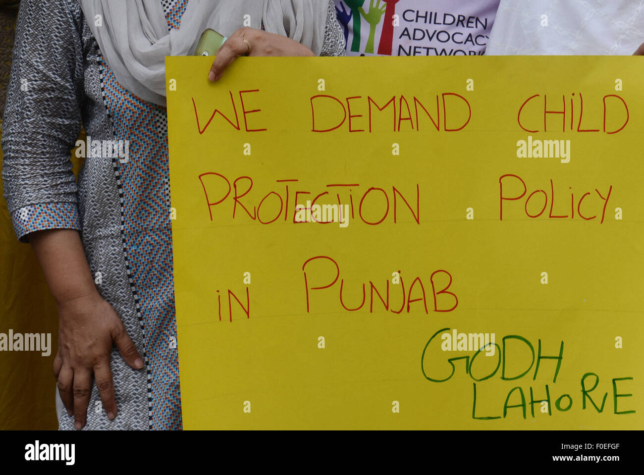 Lahore, Pakistan. 13th Aug, 2015. The activists of the Pakistani NGO Child rights Movement Punjab and Pakistan Pediatric Association Punjab hold placards during a protest against child abuse in Lahore. Three Pakistani police officers have been transferred to other districts accused of negligence amid the deepening scandal over a pedophile ring alleged to have abused hundreds of children for nearly a decade, officials said. © Rana Sajid Hussain/Pacific Press/Alamy Live News Stock Photo