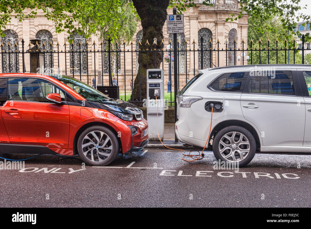 Electric cars being charged in the centre of Birmingham, West Midlands, England Stock Photo