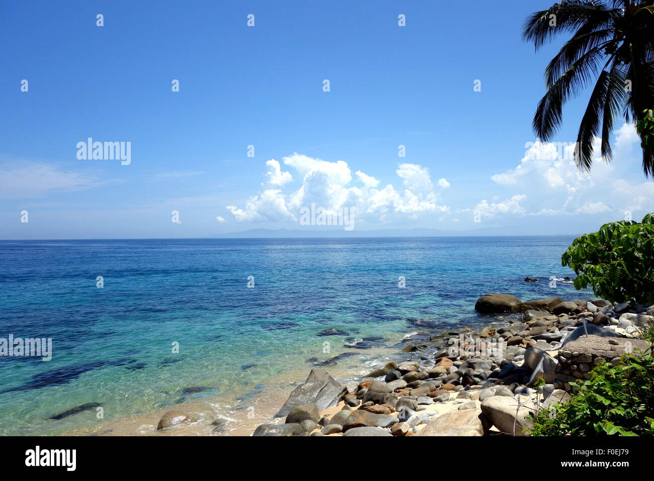 Clear turquoise blue water at a rocky beach near Puerto Vallarta, Mexico. Stock Photo