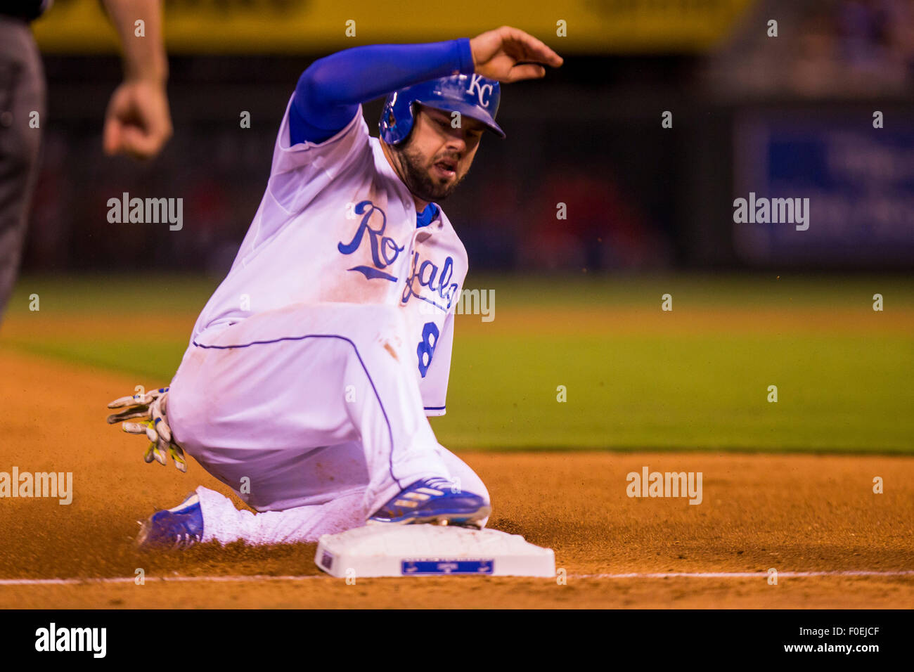 Kansas City, Missouri, USA. 13th Aug, 2015. Mike Moustakas #8 of the Kansas City Royals slides safely into third during the MLB game between the Los Angeles Angels and the Kansas City Royals at Kauffman Stadium in Kansas City MO Credit: Cal Sport Media/Alamy Live News Stock Photo
