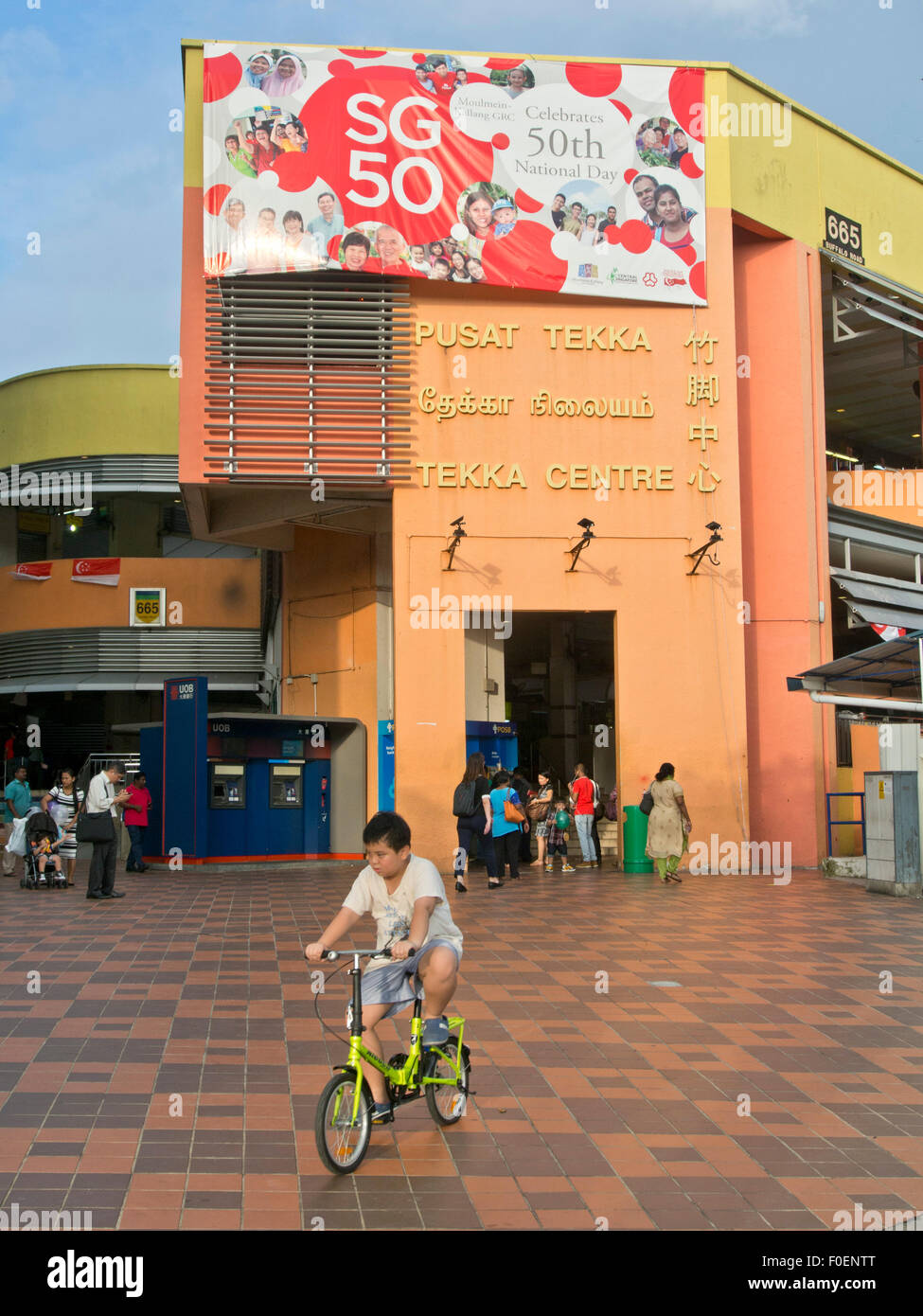 Boy Cycles Past The Tekka Centre Shopping Mall In Little India