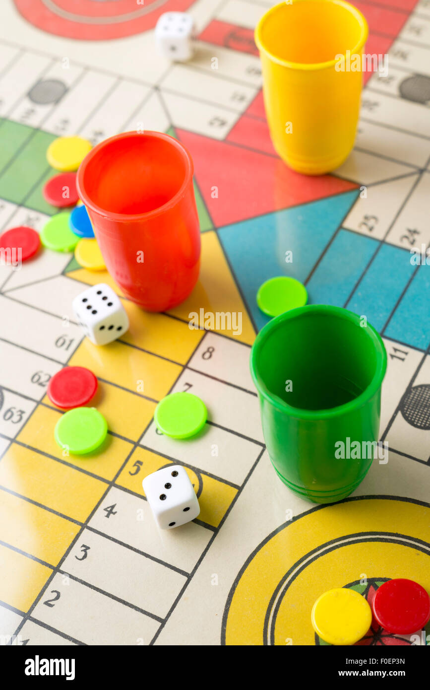 Dice, tabs and Parcheesi board game Stock Photo Alamy