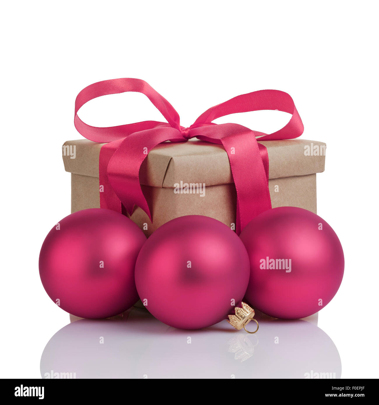 wraped gift box with purple bow, christmas balls and tag, isolated Stock Photo