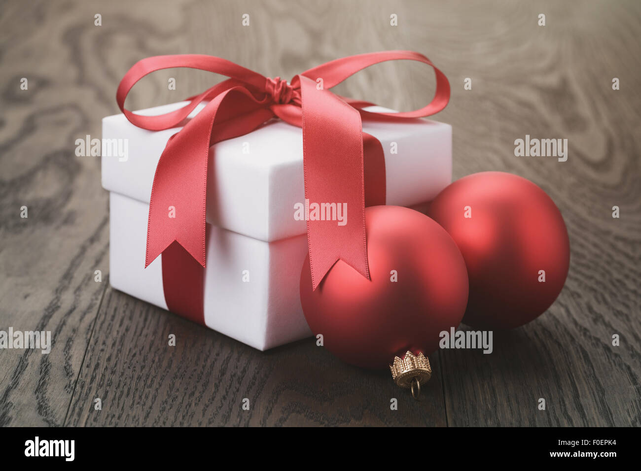 gift box with red bow on rustic table Stock Photo