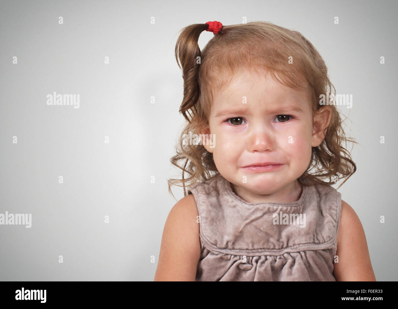 Portrait of crying baby girl, with copy-space Stock Photo
