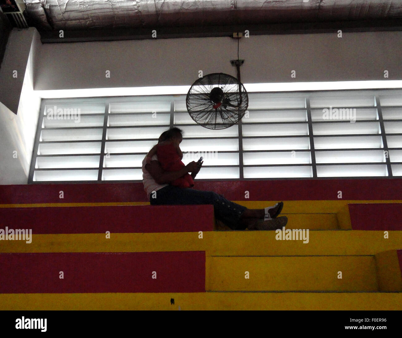 Malabon City, Philippines. 14th Aug, 2015. A Filipino mother rests with ...