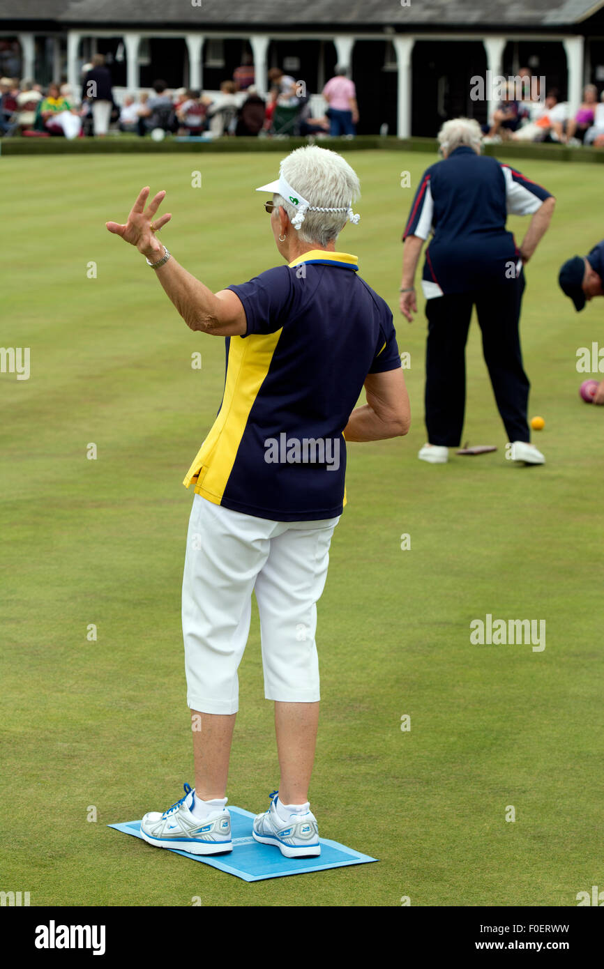 Woman lawn bowls player signalling Stock Photo