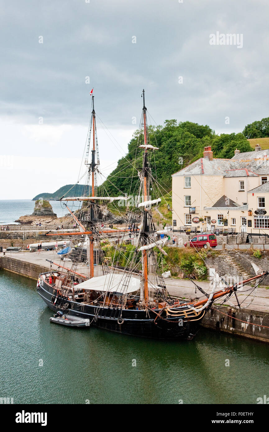 Charlestown historic harbour, Cornwall, with the square-rigged sailing ship "Phoenix of Dell Quay" berthed in the dock Stock Photo