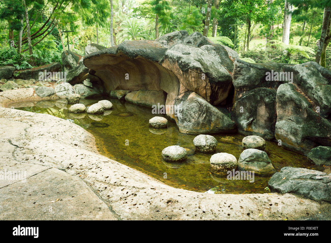 prehistoric landscape with scenic stone cliffs and caverns in Singapore Botanical garden Stock Photo