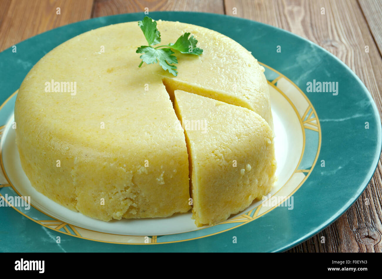 Mamaliga -  porridge made out of yellow maize flour, traditional in Romania, Moldova, and Western Ukraine. Stock Photo
