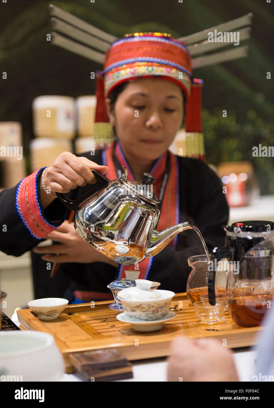 Hong Kong. 14th Aug, 2015. Chinese provincial lady serves tea. Guests ...