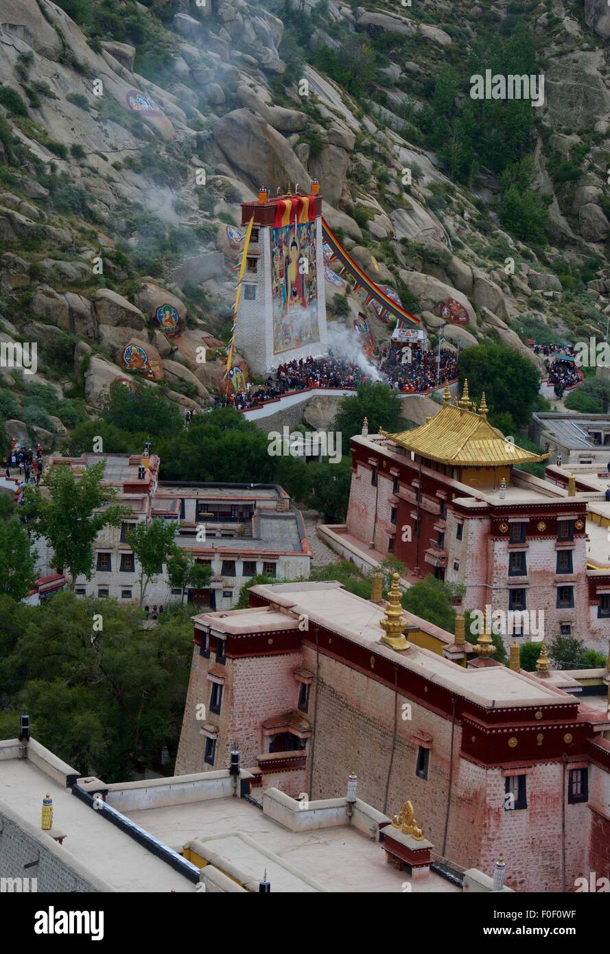 Lhasa. 14th Aug, 2015. Photo taken on Aug. 14, 2015 shows the ceremony held to unfold a huge Buddha painting during the annual traditional Shoton (Yogurt) Festival at Sera Monastery in Lhasa, capital of southwest China's Tibet Autonomous Reigion. Credit:  Purbu Zhaxi/Xinhua/Alamy Live News Stock Photo