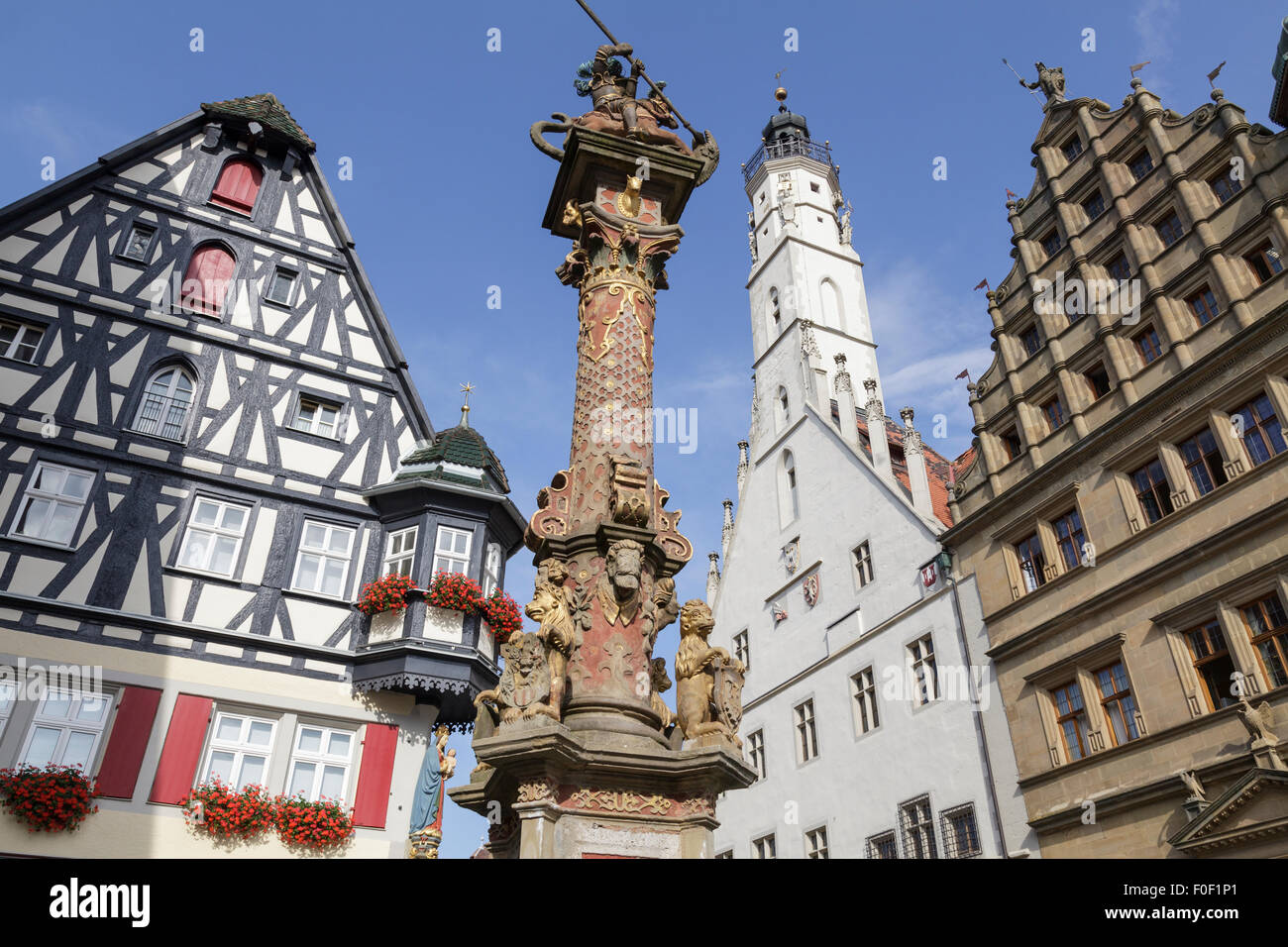 pillar on Georges Spring with the Town Hall tower, Rothenburg ob der Tauber, Franconia, Bavaria, Germany Stock Photo