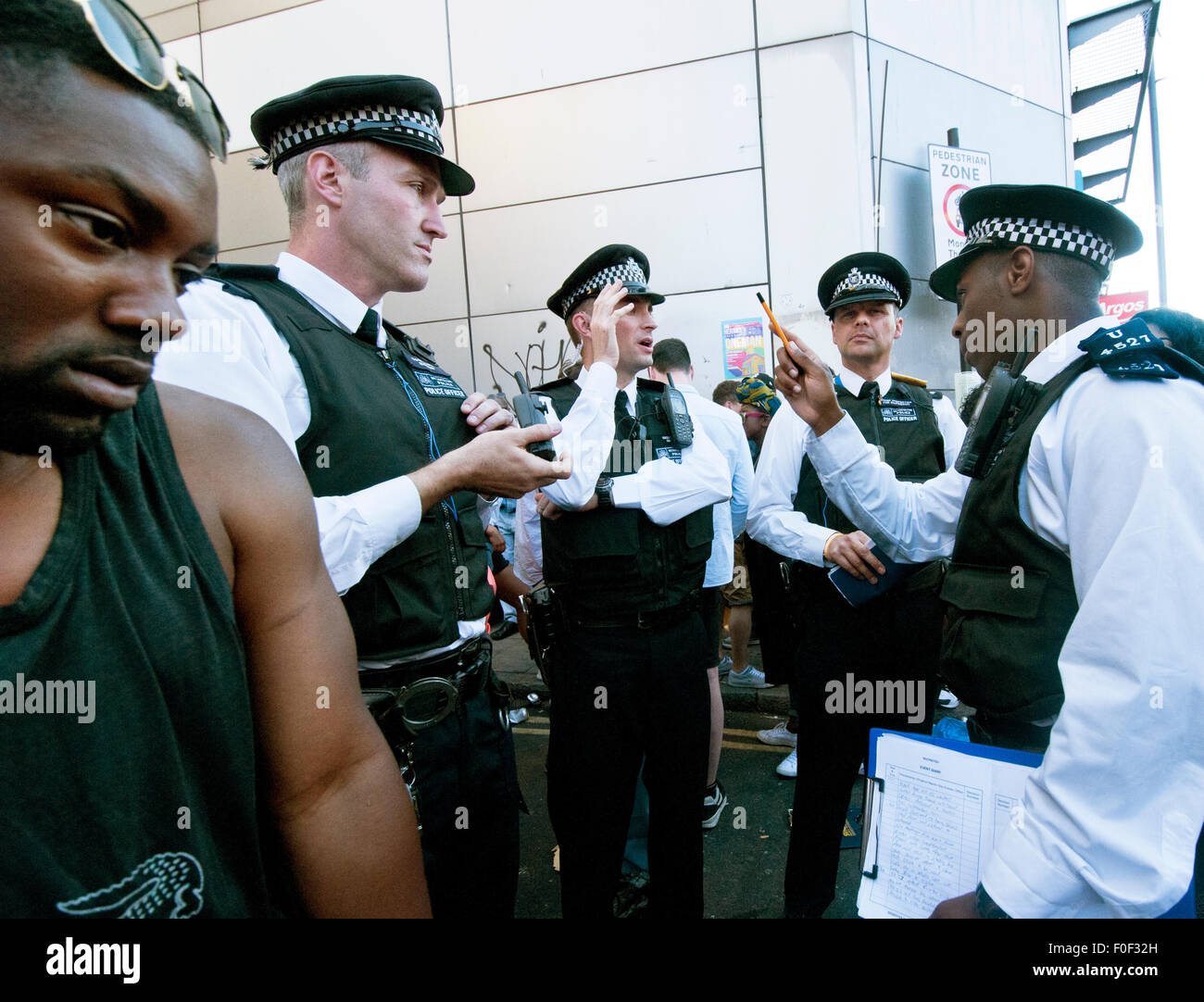 Policeman instructing group of police officers at Brixton Splash festival Stock Photo