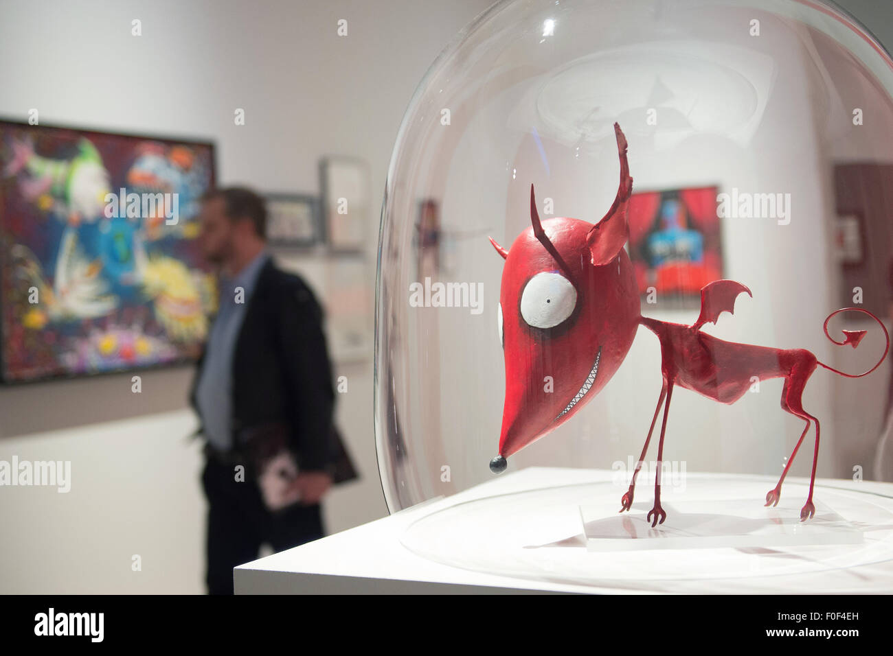 A journalist at the exhibition 'The World of Tim Burton' at the Max Ernst  museum in Bruehl, Germany, 14 August 2015. In the foreground is a model of  