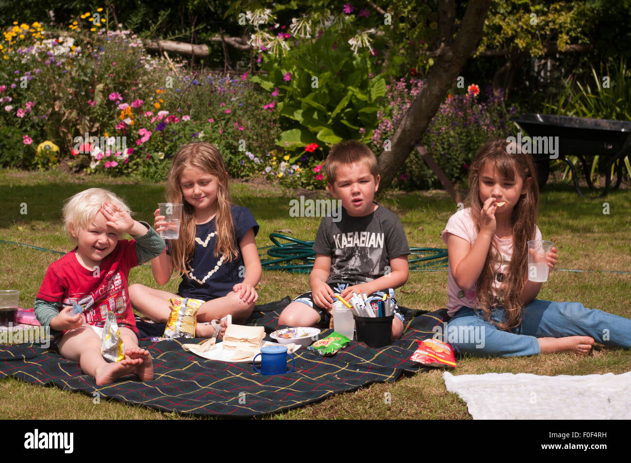 Children having a Picnic In The Garden On a summers day Stock Photo