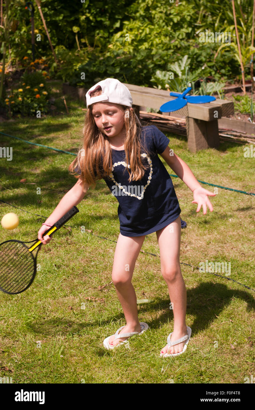 Little Girl Playing Bat and Ball In The Garden Stock Photo Alamy