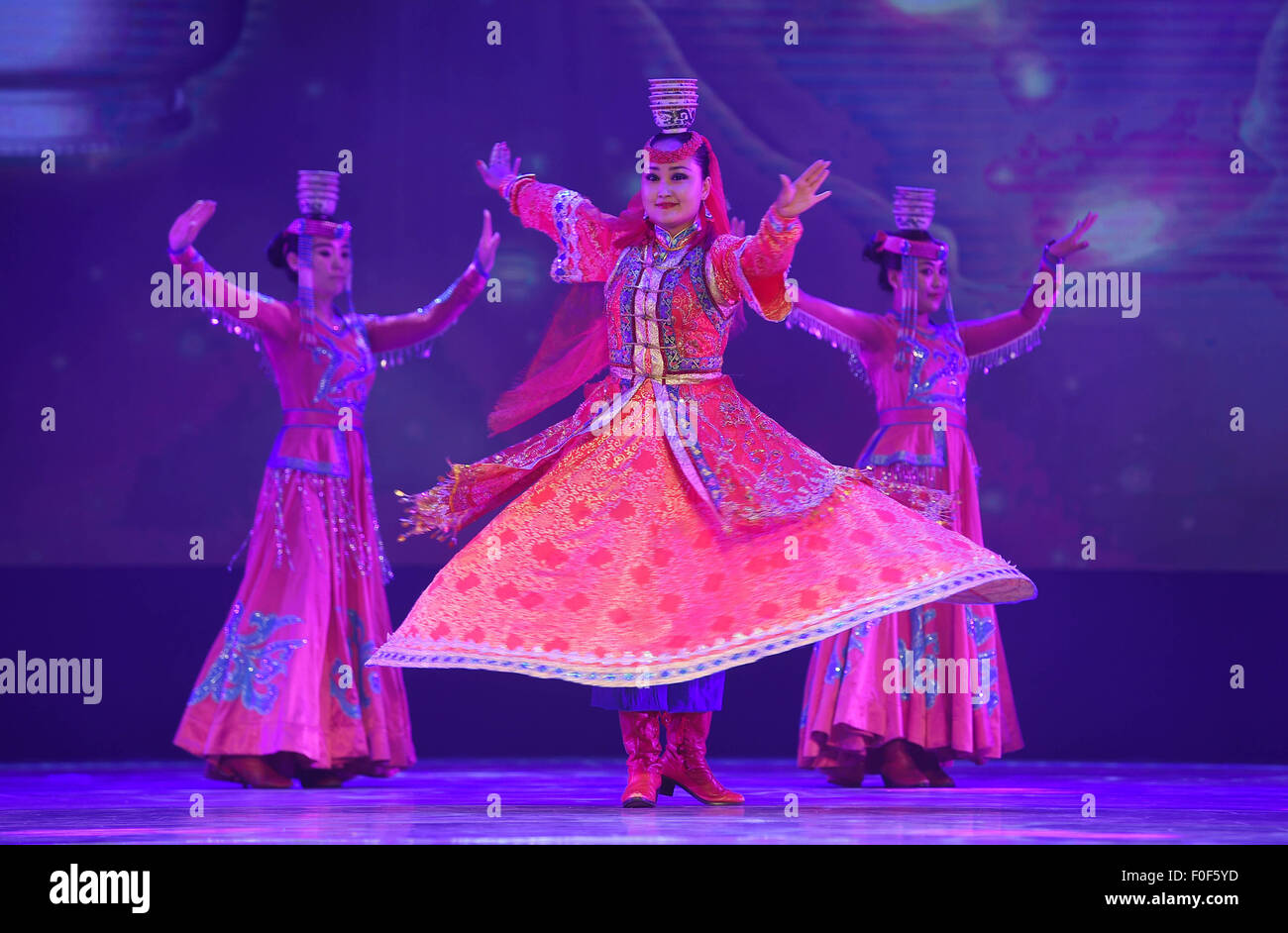 Ordos, China's Inner Mongolia Autonomous Region. 14th Aug, 2015. Performers dance at the culture show Ordos Wedding Ceremony during the 10th National Traditional Games of Ethnic Minorities of China in Ordos, north China's Inner Mongolia Autonomous Region, Aug. 14, 2015. The 10th National Traditional Games of Ethnic Minorities of China provided a platform for sport and culture communication between different ethnic groups of China. © Wang Peng/Xinhua/Alamy Live News Stock Photo