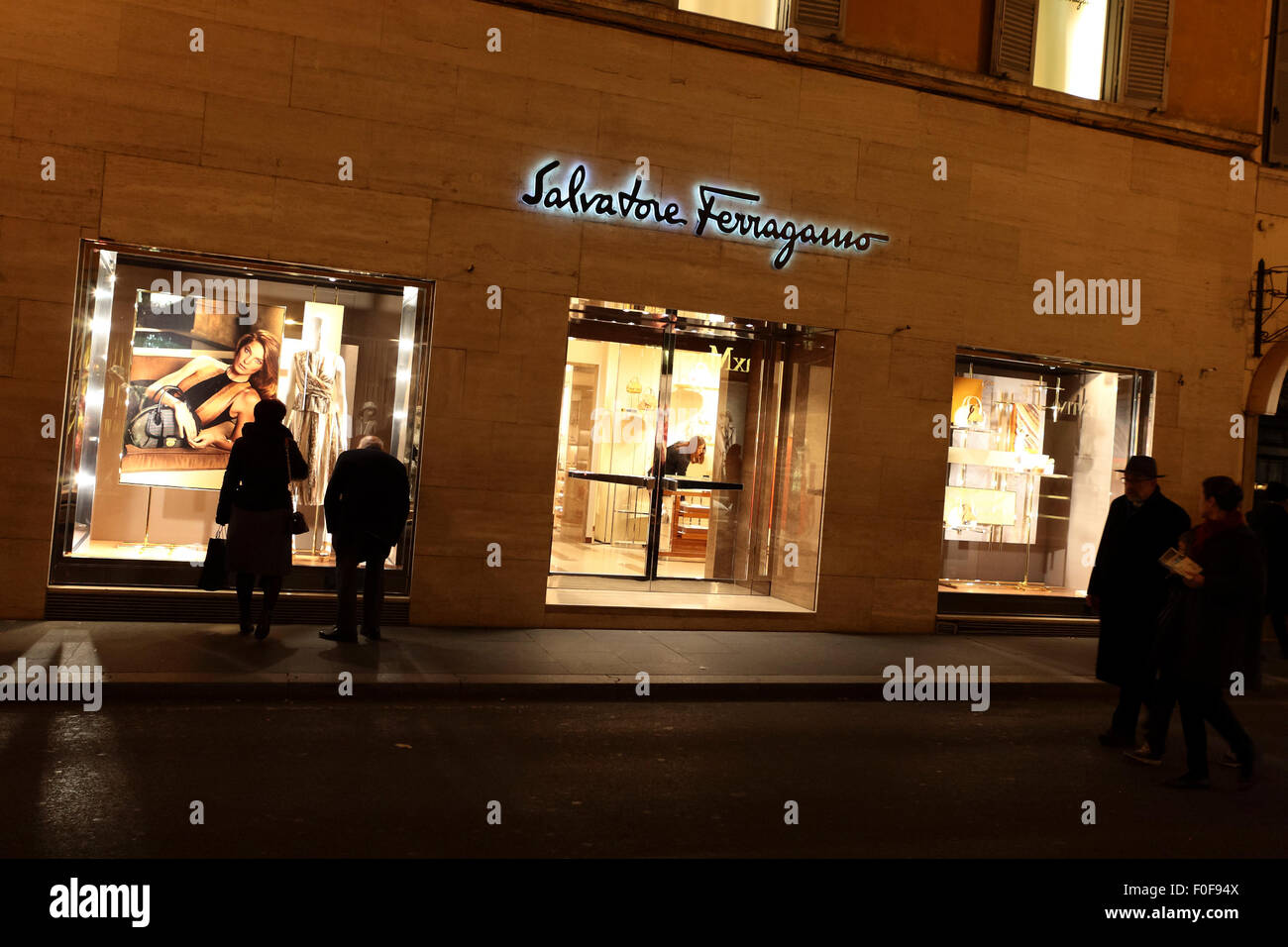 Night time window shopping in a high end fashion boutique on Via Condotti, Rome, Italy. Stock Photo