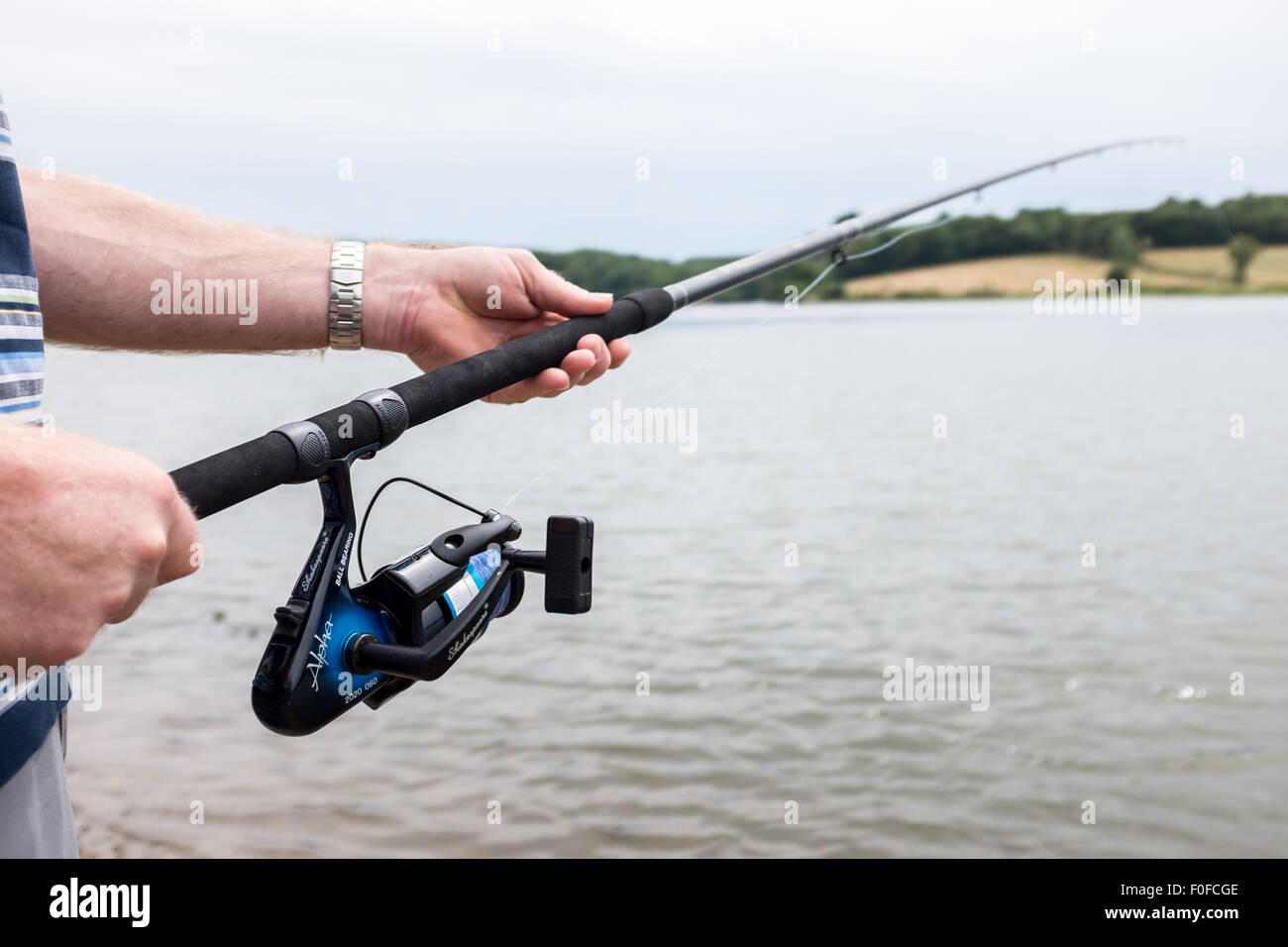Man holding rod, fly fishing in a lake Stock Photo Alamy