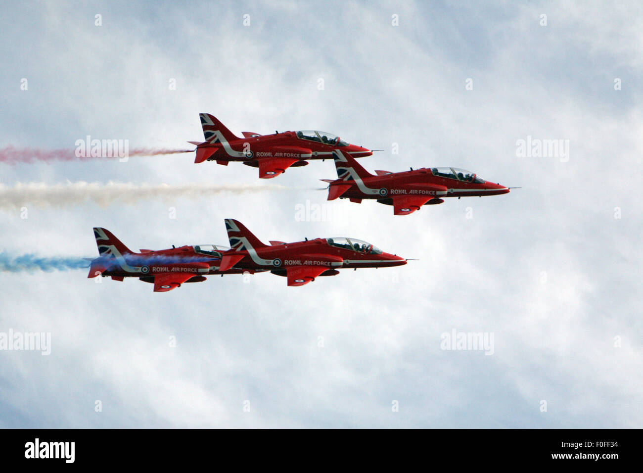 Red Arrows leaving  vapour trails above Falmouth Stock Photo
