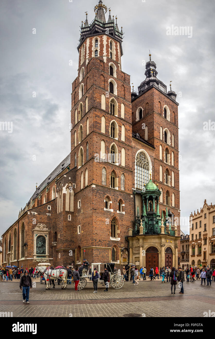 CRACOW, POLAND - MAY 01, 2015: anonymous tourists visiting Mariacki church at the Main Square in Cracow ( Krakow ), Poland Stock Photo