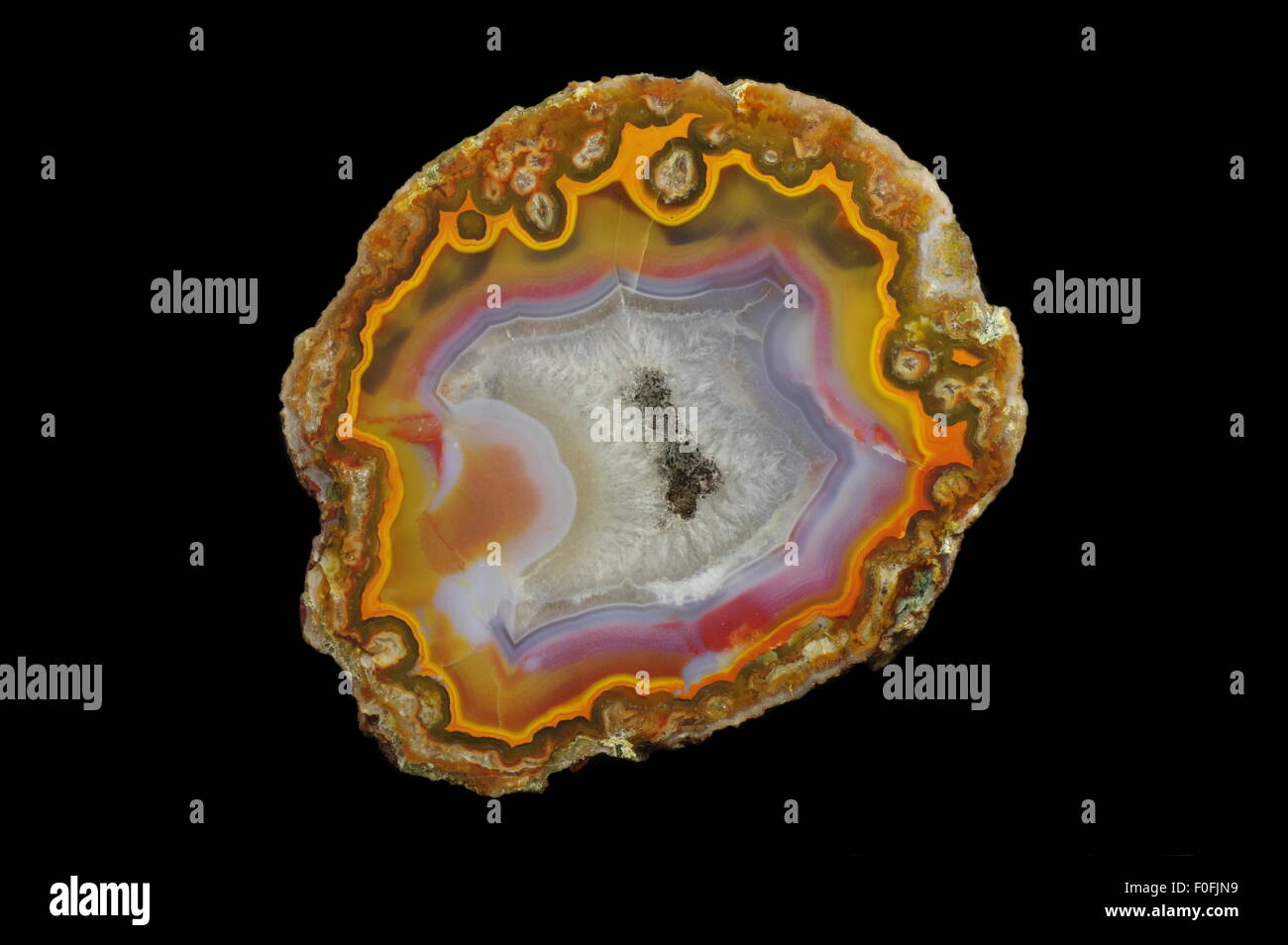 Agate, a cross section of agate stone with geode on a black background ...
