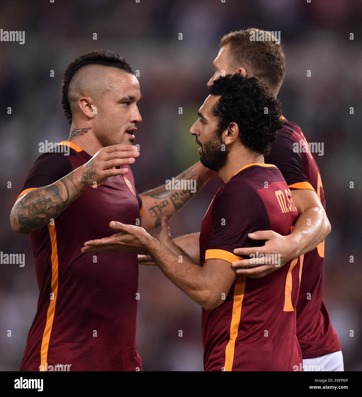 Rome, Italy. 14th Aug, 2015. Salah (C) of AS Roma celebrates his goal during a friendly match against Sevilla in Rome, Italy, on Aug. 14, 2015. AS Roma won 6-4. Credit:  Alberto Lingria/Xinhua/Alamy Live News Stock Photo
