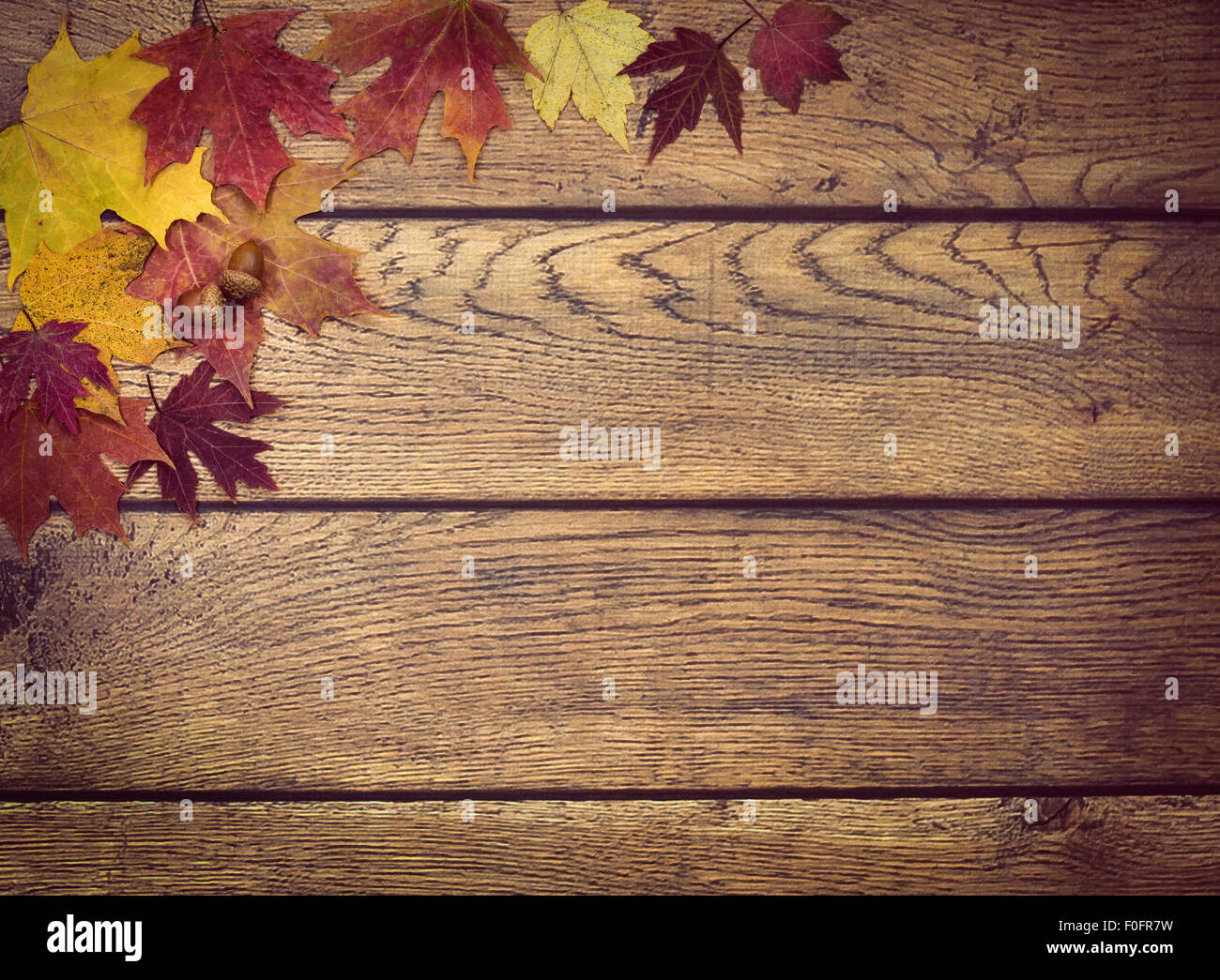 Autumn leaves and acorns on rustic wooden background Stock Photo - Alamy
