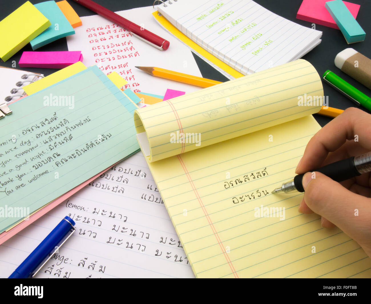 Writing new words again and again to learn new language. Stock Photo