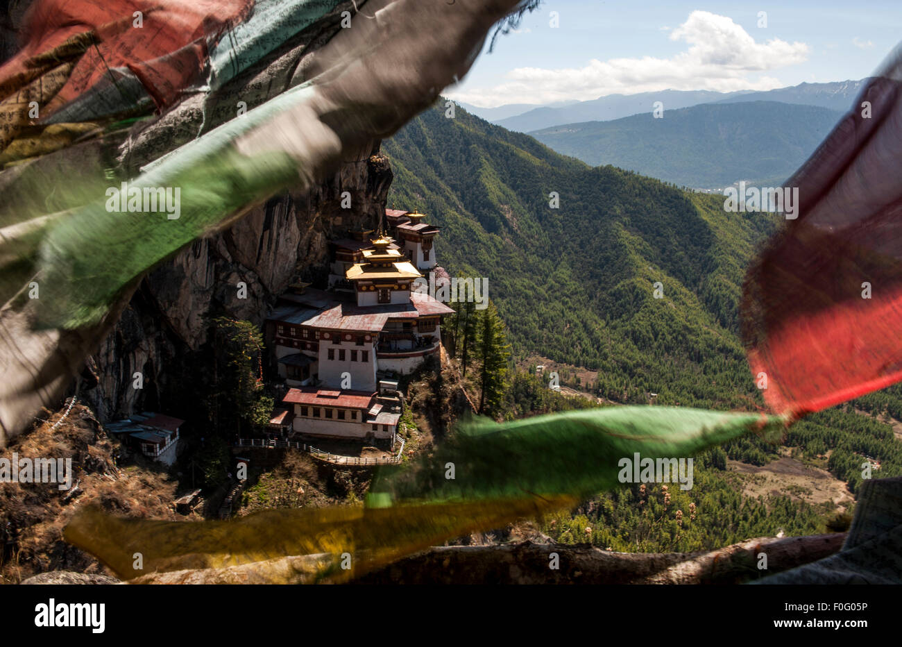 Taktsang or Tiger's Nest Monastery with colourful prayer flags in the foreground Paro Valley Bhutan Stock Photo