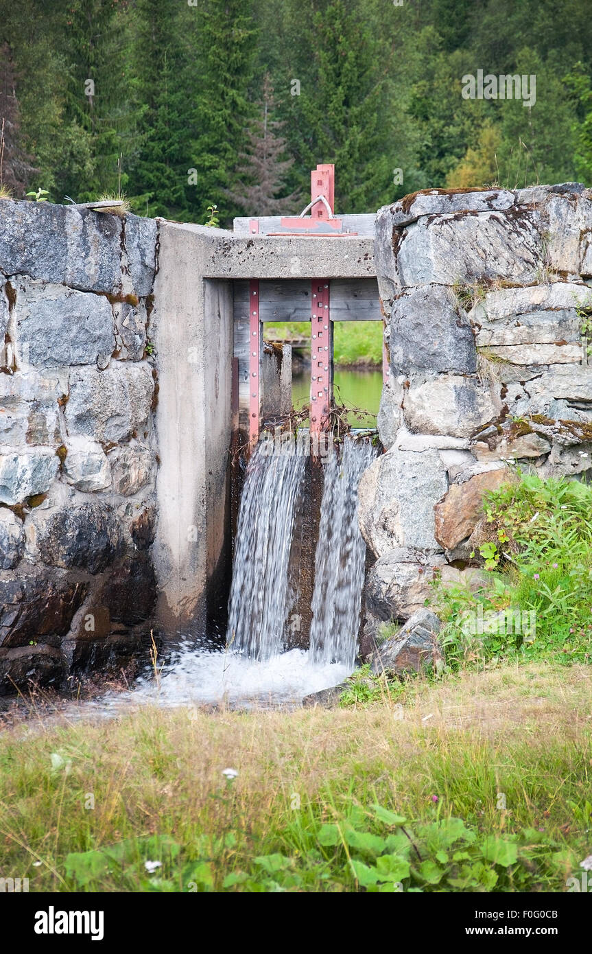 Dam construction with falling water near Ostersund in Northern Sweden on an overcast day. Stock Photo