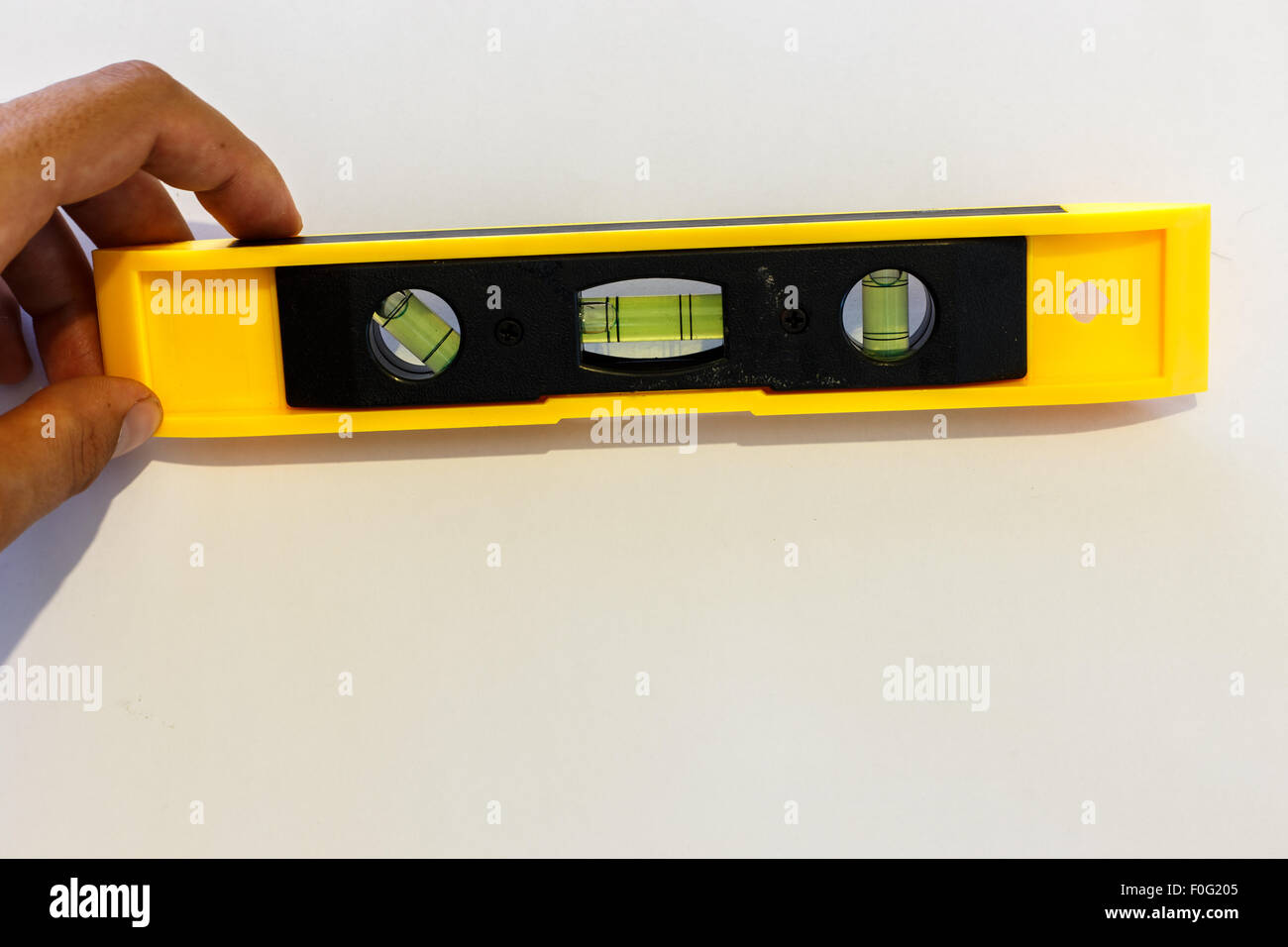 Yellow spirit level isolated on white background. Stock Photo
