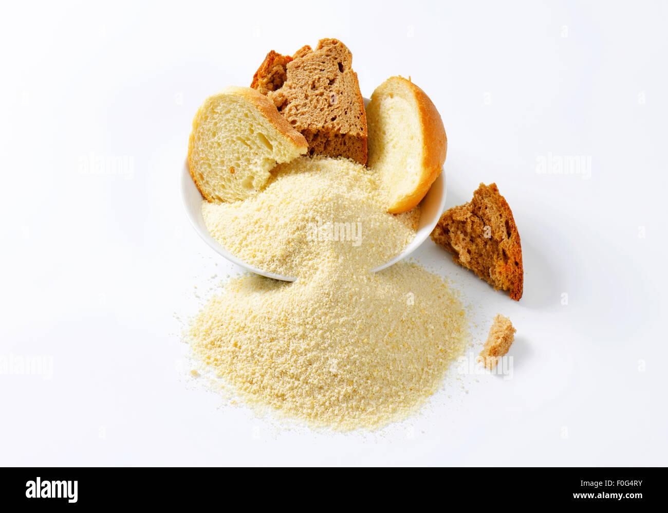 Pieces of stale bread and pile of finely ground bread crumbs Stock Photo