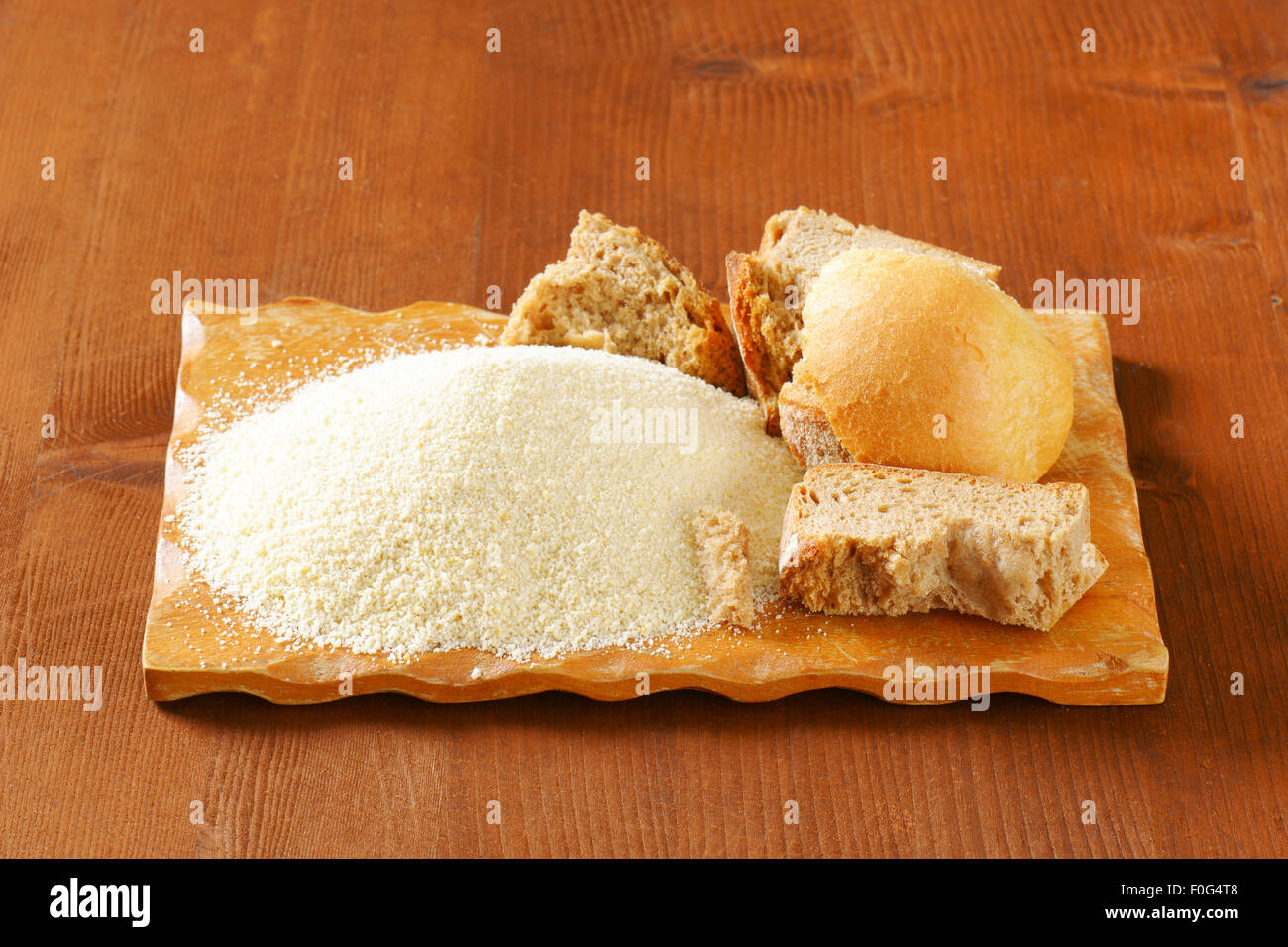 Pieces of stale bread and pile of finely ground bread crumbs Stock Photo