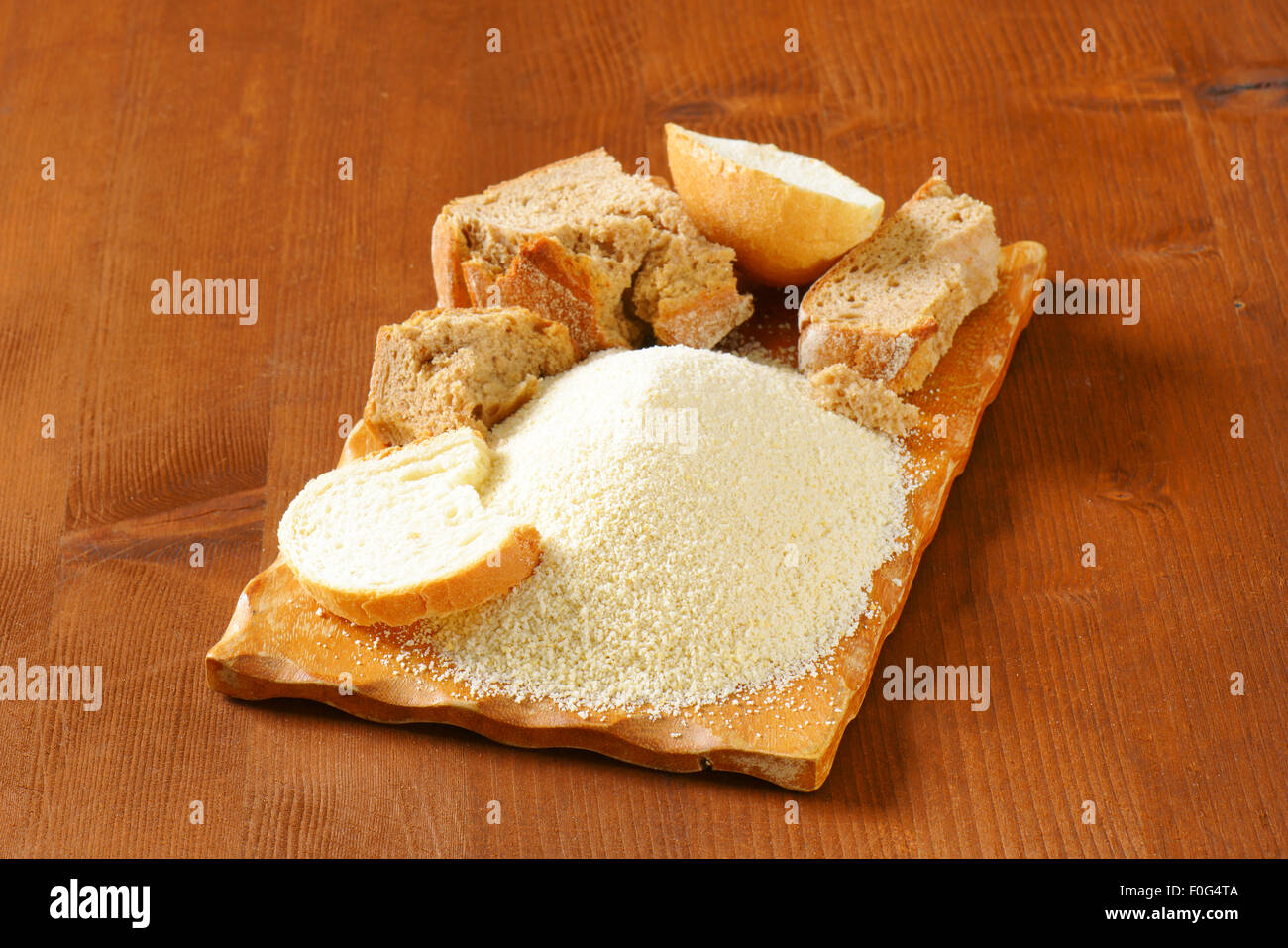 Pieces of stale bread and pile of finely ground bread crumbs Stock Photo