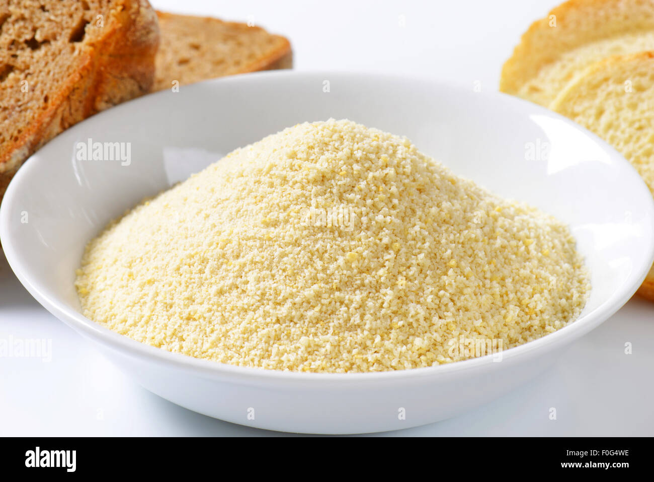 Pieces of stale bread and pile of finely ground bread crumbs Stock Photo