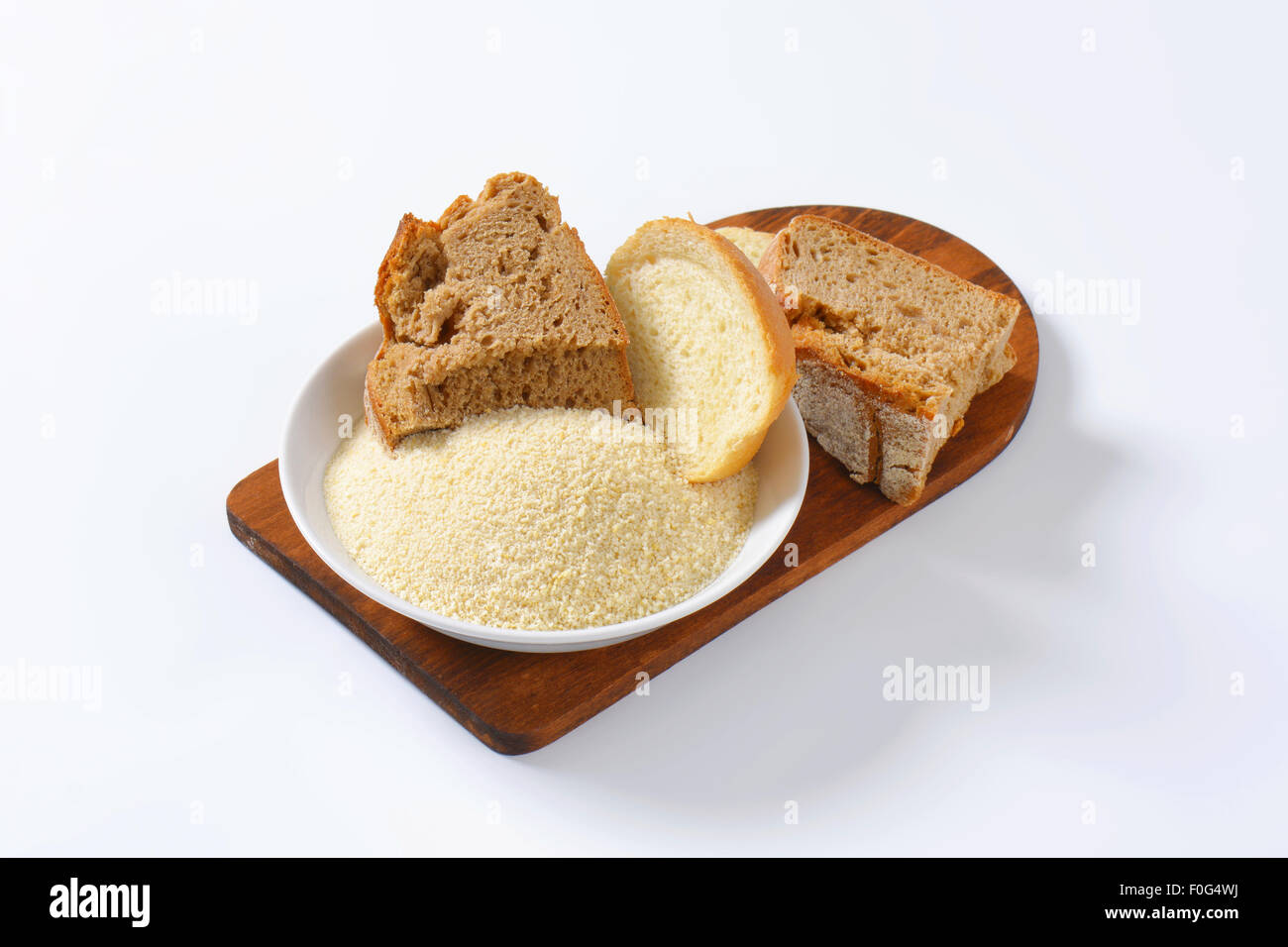 Pieces of stale bread and pile of finely ground bread crumbs Stock Photo