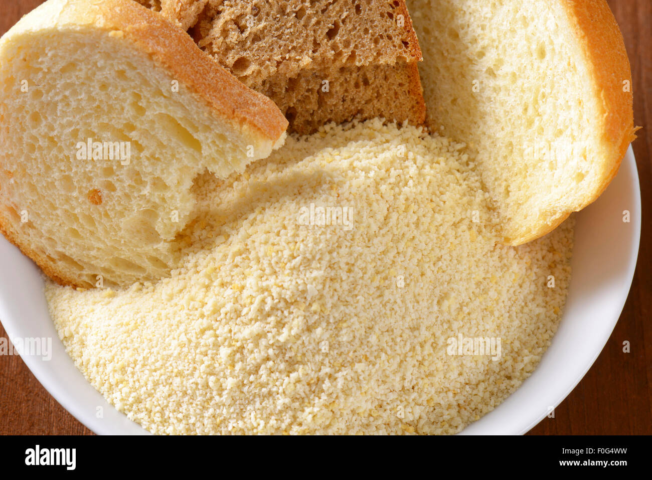 Pieces of stale bread and pile of finely ground bread crumbs Stock Photo