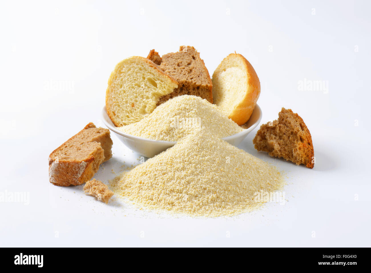 Pieces of stale bread and pile of finely ground bread crumbs Stock