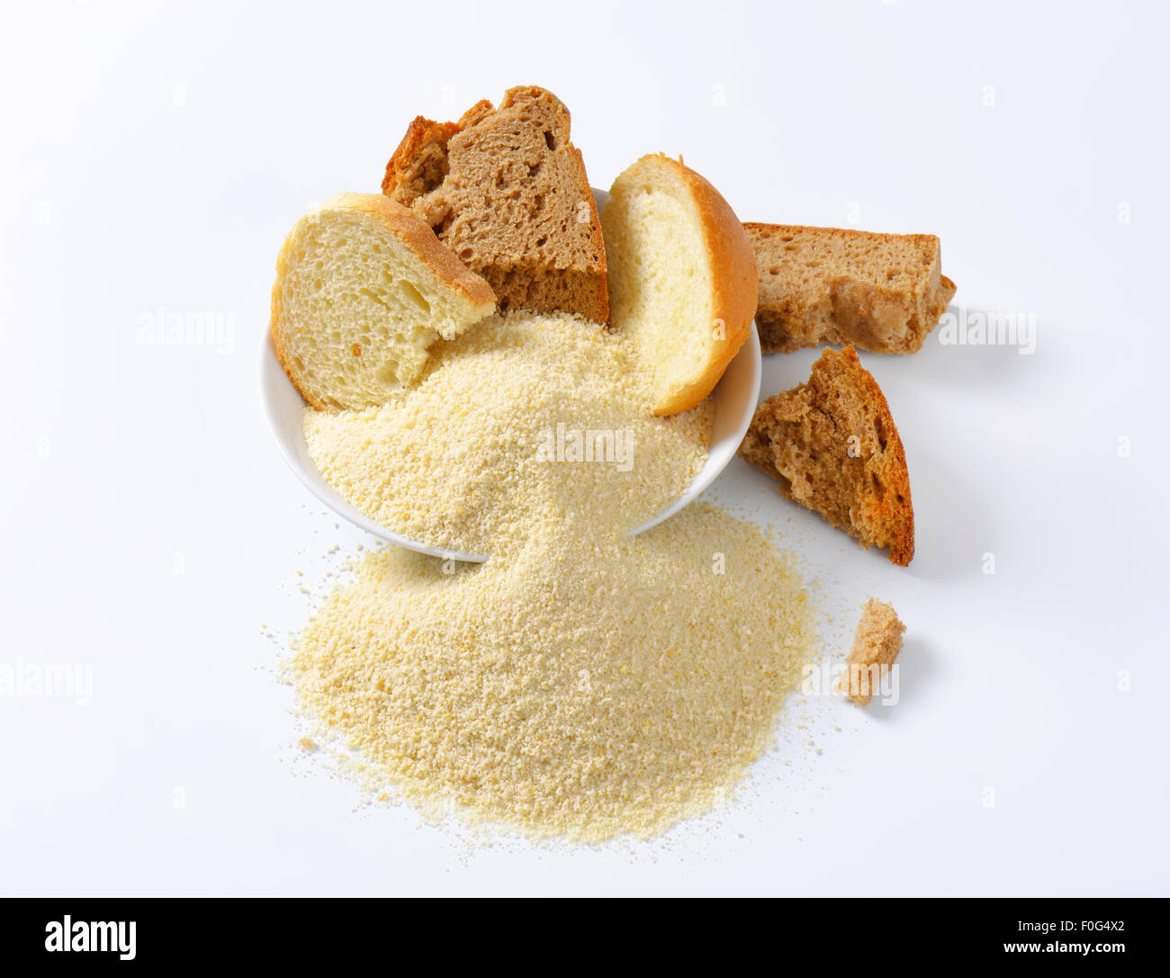 Pieces of stale bread and pile of finely ground bread crumbs Stock Photo