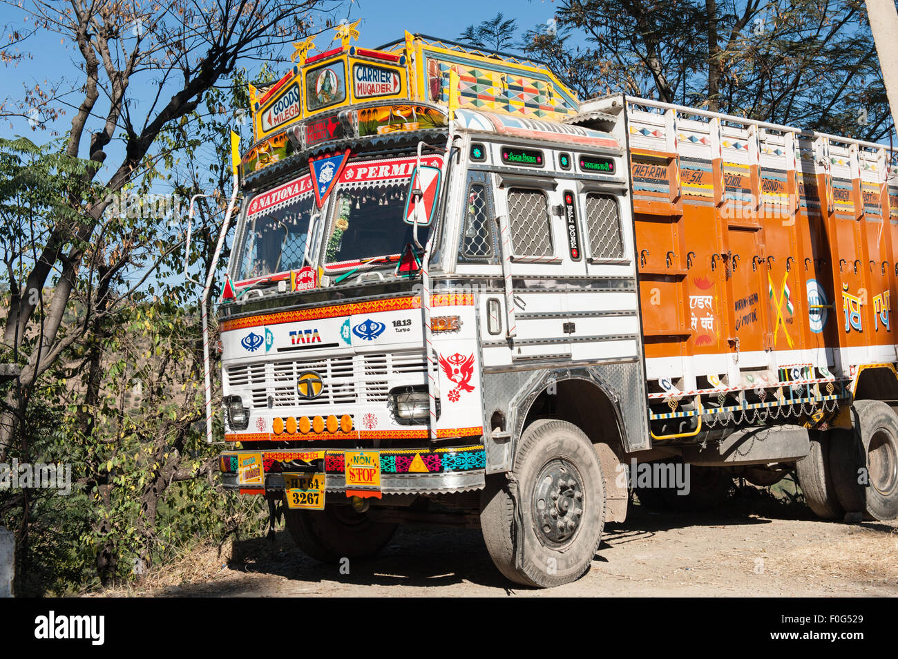 Himachal Pradesh, India. Colourful Tata truck personalised by its owner with brightly painted motifs and decorations; Dharamsala to Shimla. Stock Photo