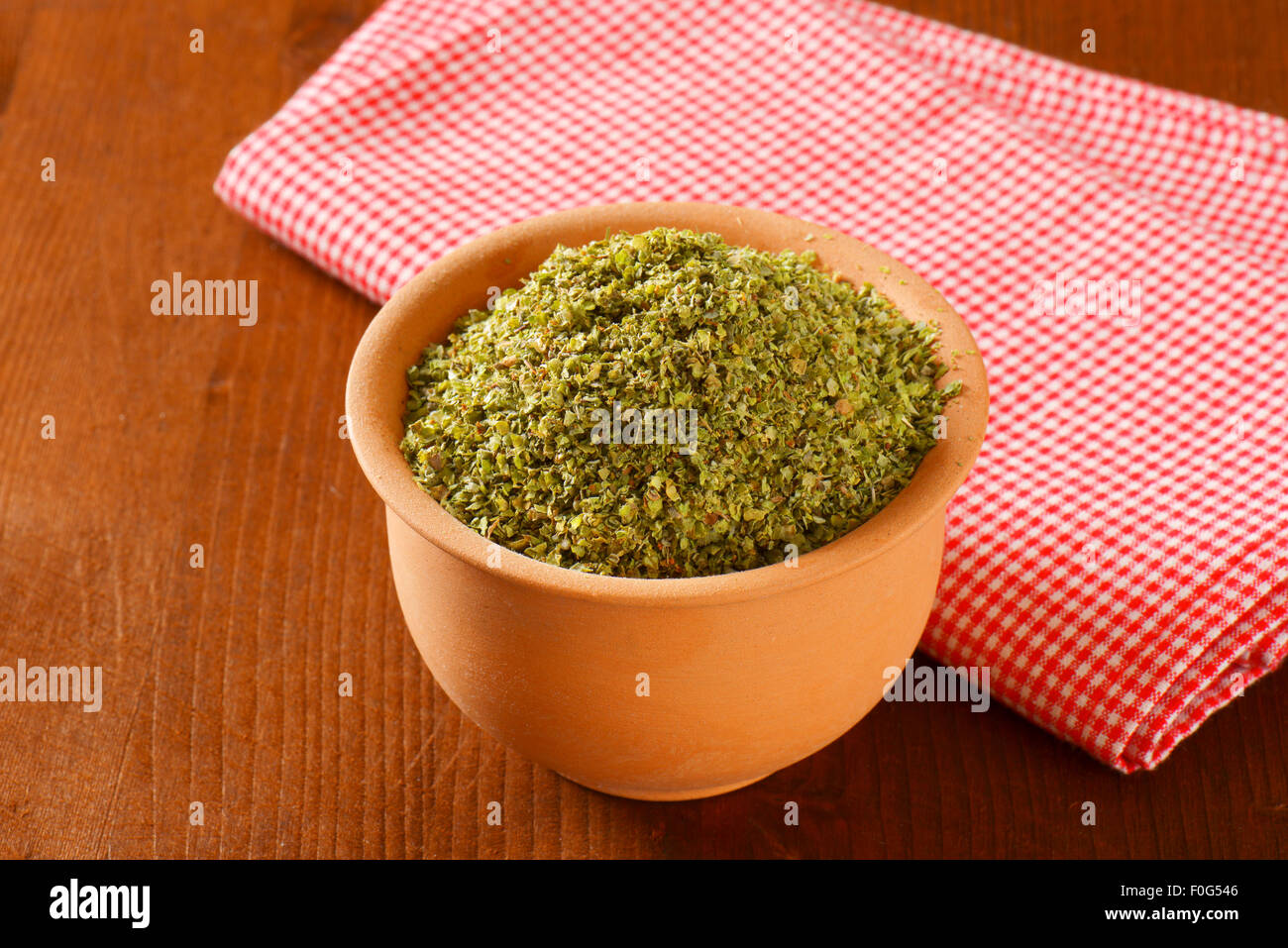Heap of dried Marjoram leaves in terracotta bowl Stock Photo Alamy